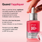 Anua skincare serum bottle with dropper on a pink background