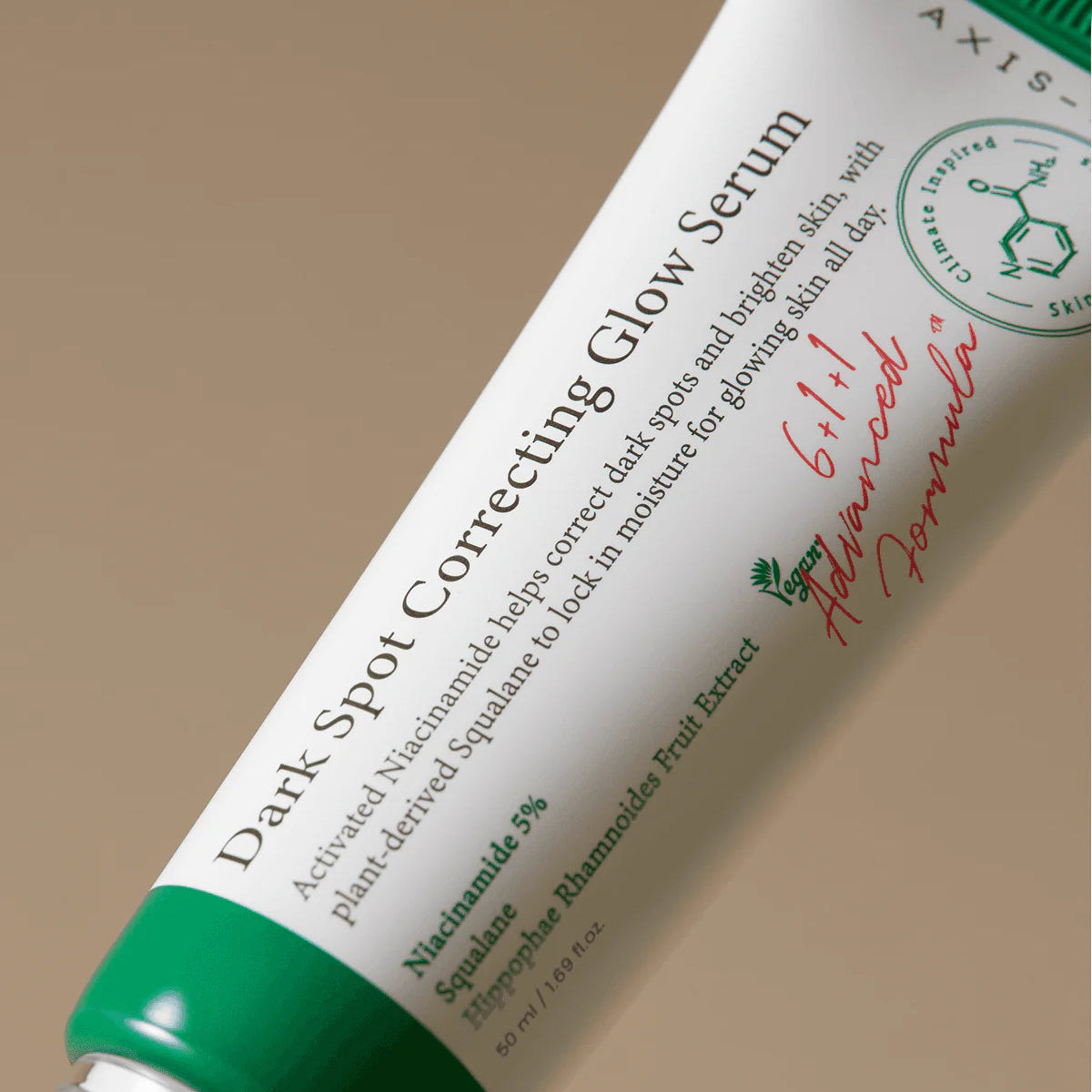 Tube of Axis Skincare Dark Spot Correcting Glow Serum on a beige background