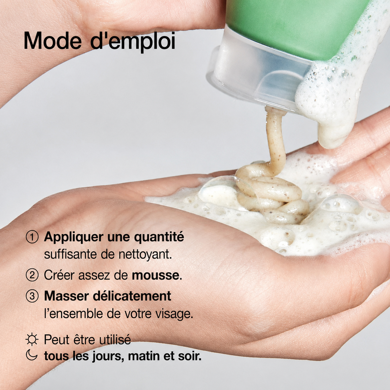 Hand applying a green bottle of facial cleanser with text instructions on a gray background