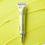 Skincare serum tube on a yellow leaf background