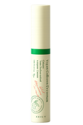 Skincare serum bottle with green label on a white background
