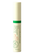 Skincare serum bottle with green label on a white background