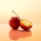 Cherry with a halved section on a reflective surface